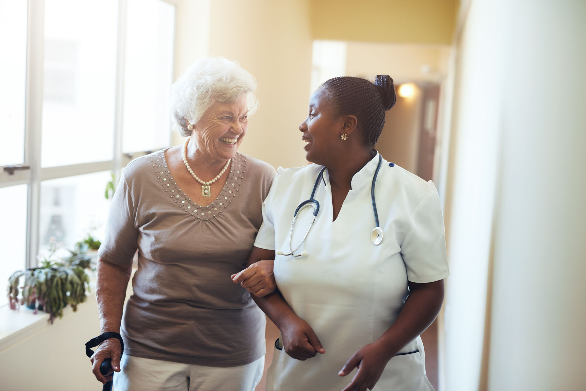 A nurse walking with a patient