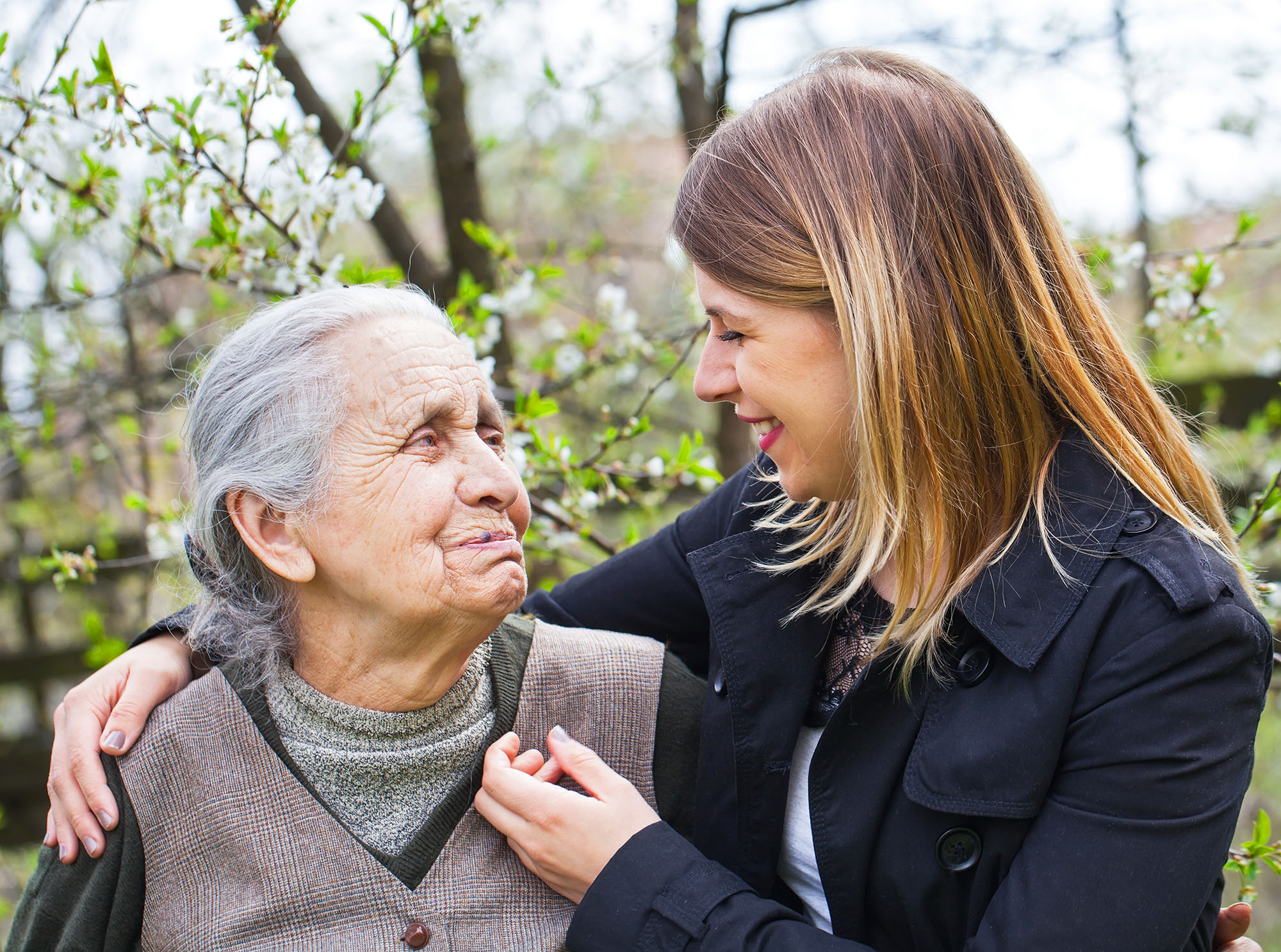 Two women greeting each other smiling