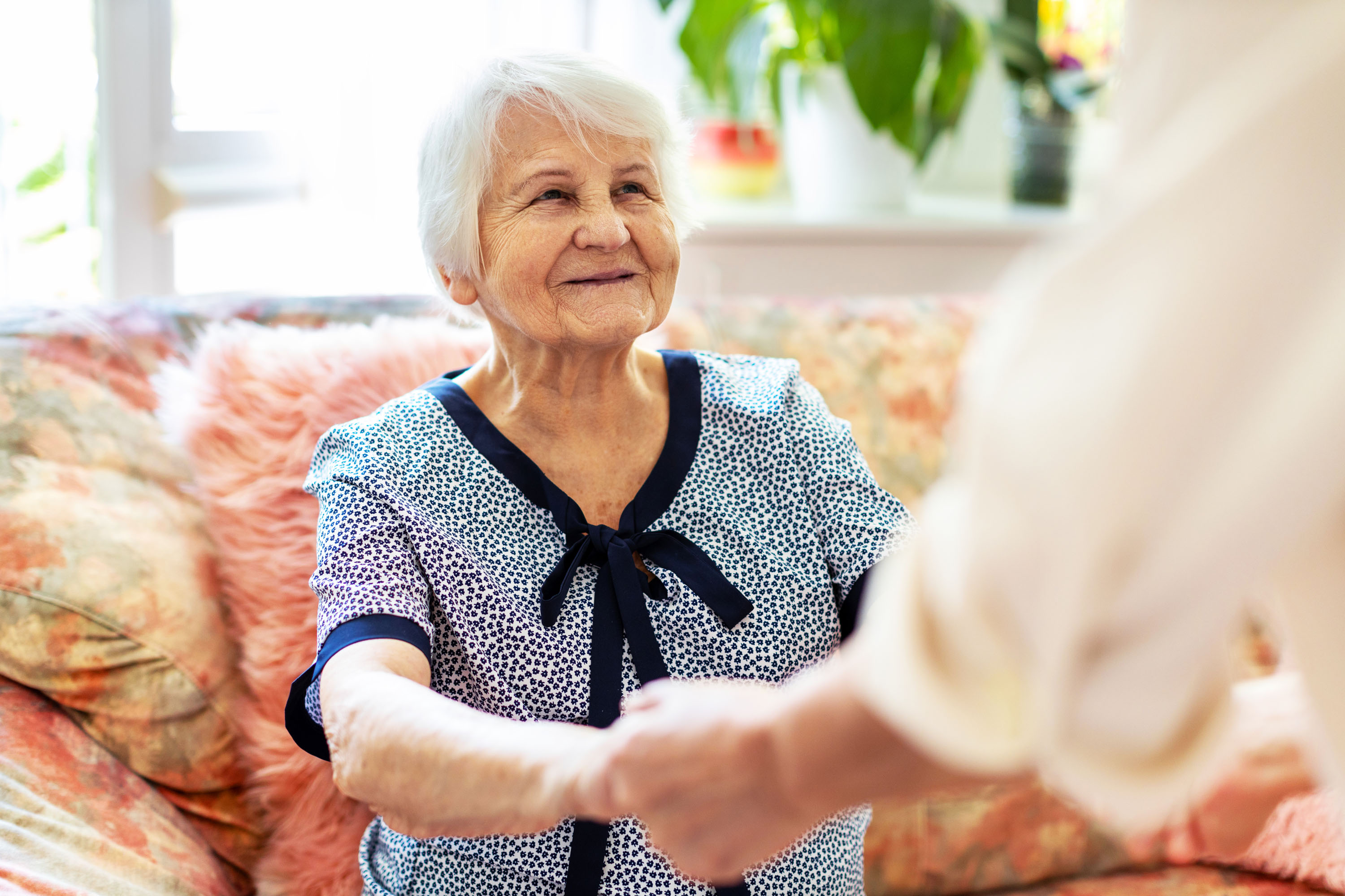 A woman holding hands smiling