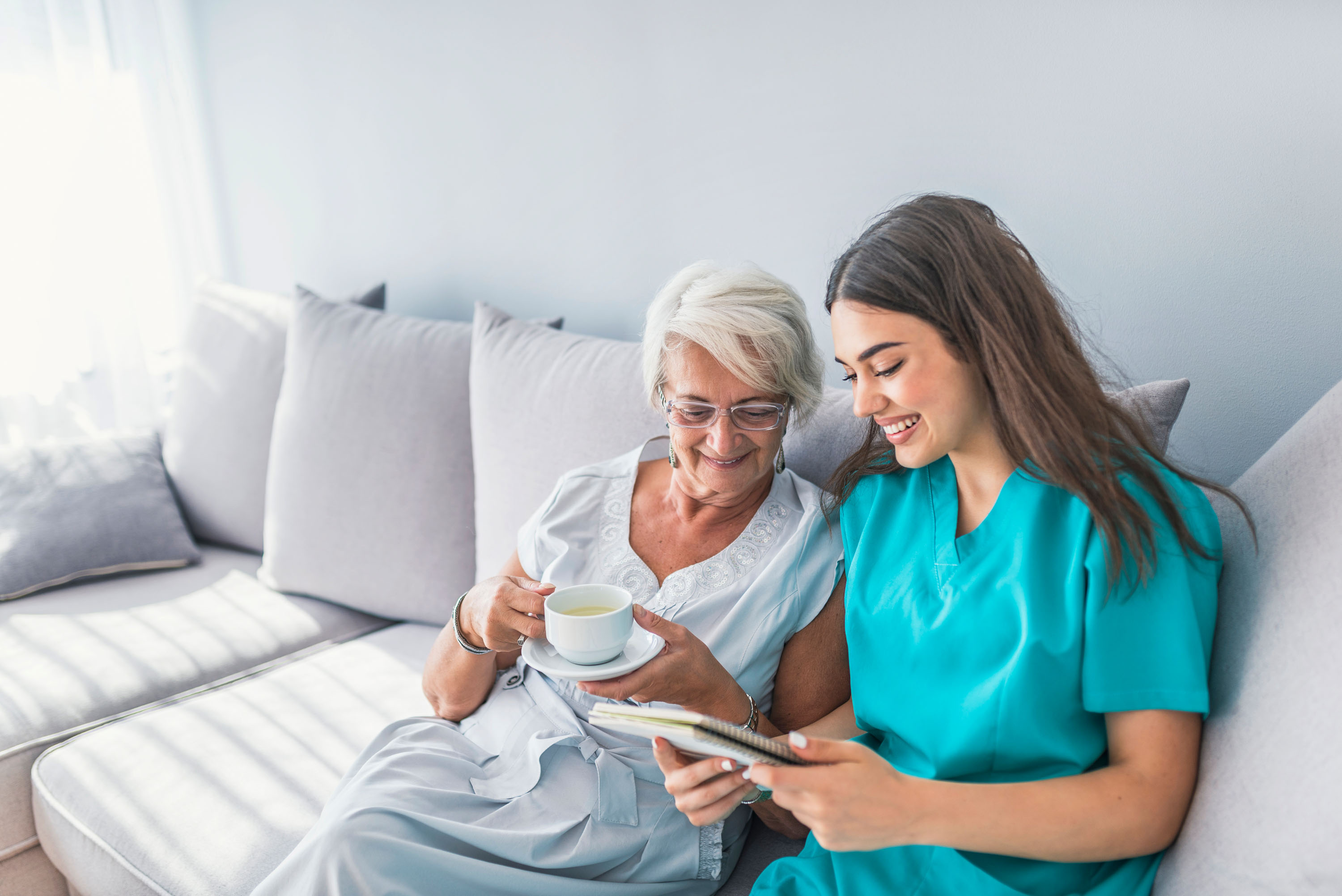 A nurse reading to a woman